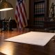 Unsigned legal order and fountain pen on a wooden desk under a lamp